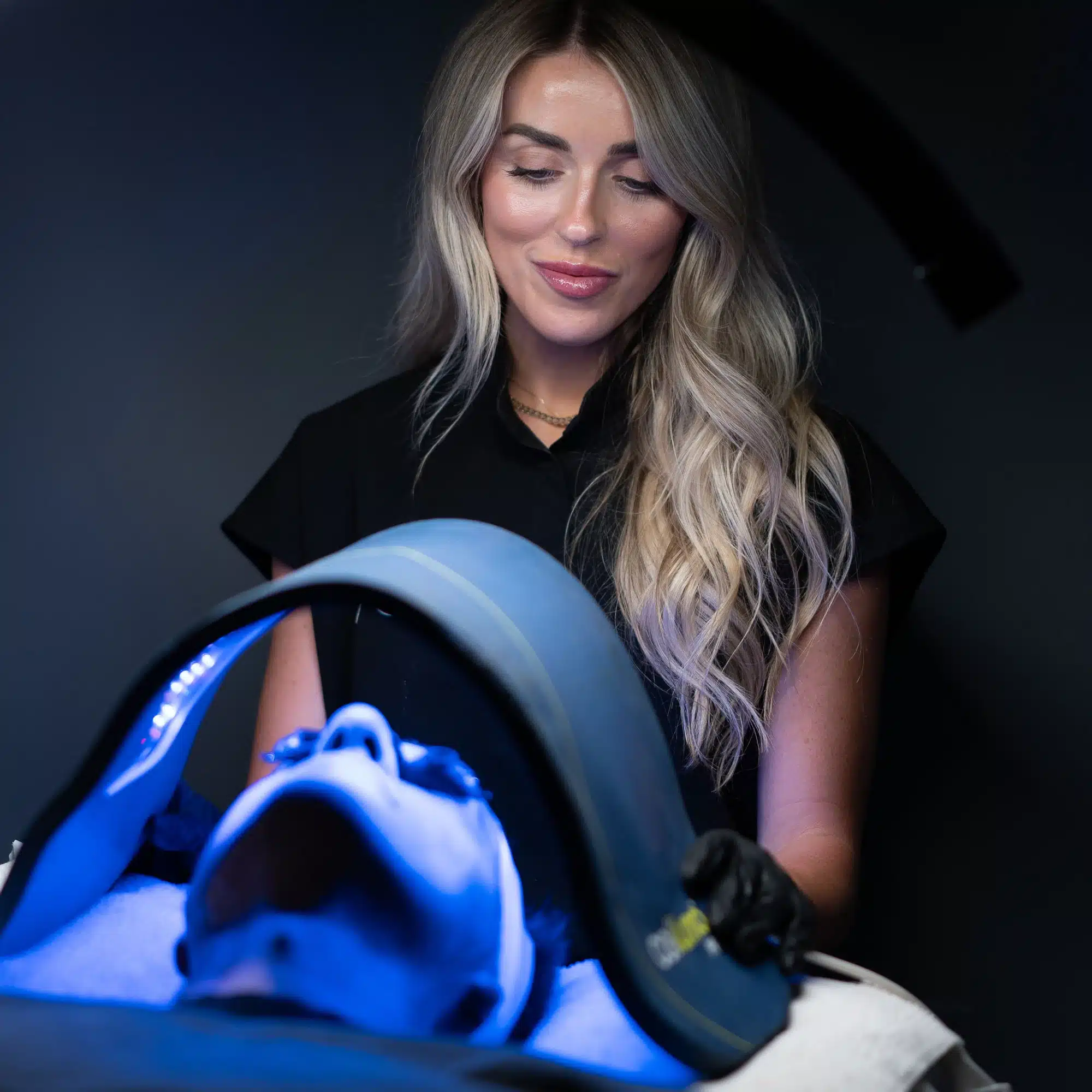VIO Med Spa provider administering an LED light therapy facial treatment